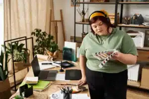A imagem mostra uma jovem mulher, trabalhando em seu ateliê de arte e ilustra o texto sobre estrangeiro trabalhar no Brasil.
