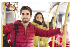The image shows a young man traveling by bus. ilustrating the article 