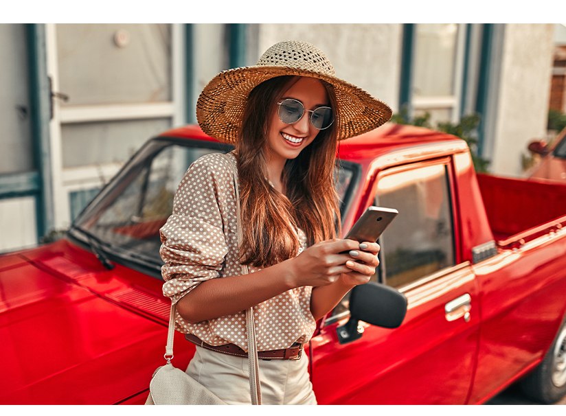 The image shows a smiling young woman with her cell phone. The image illustrates the text 