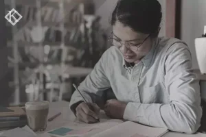 Woman sitting at a table taking notes. The image illustrates the publication 