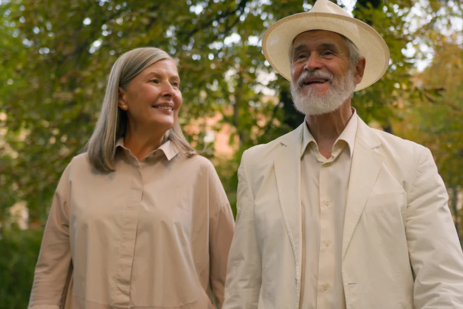 The image shows a senior couple, outdoors, walking and smiling. It illustrates the text about residence visa for foreign retirees in Brazil.