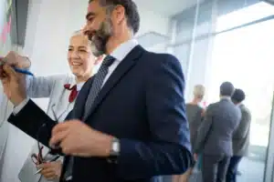 The image shows two partners working together in a business environment. The image illustrates the text about partnership agreement.