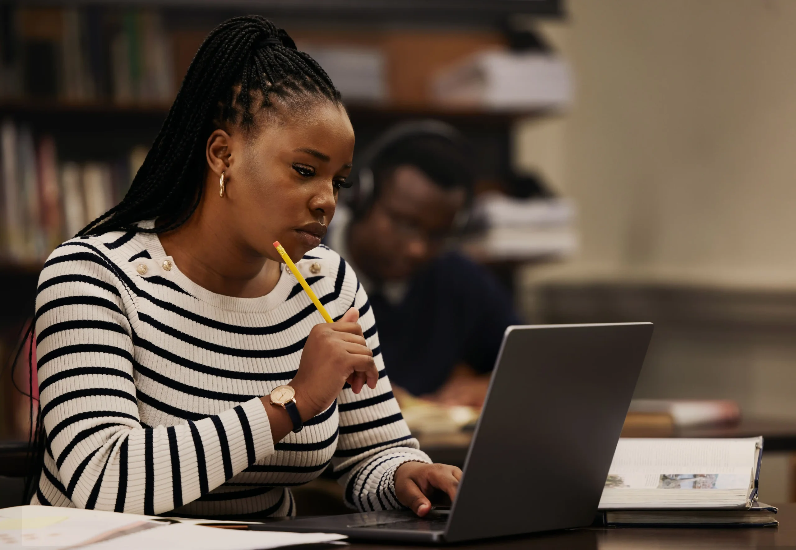 The image shows a young woman studying in a library. It illustrates the text about the Apprenticeship Visa.