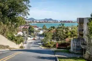 The image shows a view of Jurerê beach in Florianópolis, Santa Catarina, Brazil. It illustrates the text about Florianópolis.