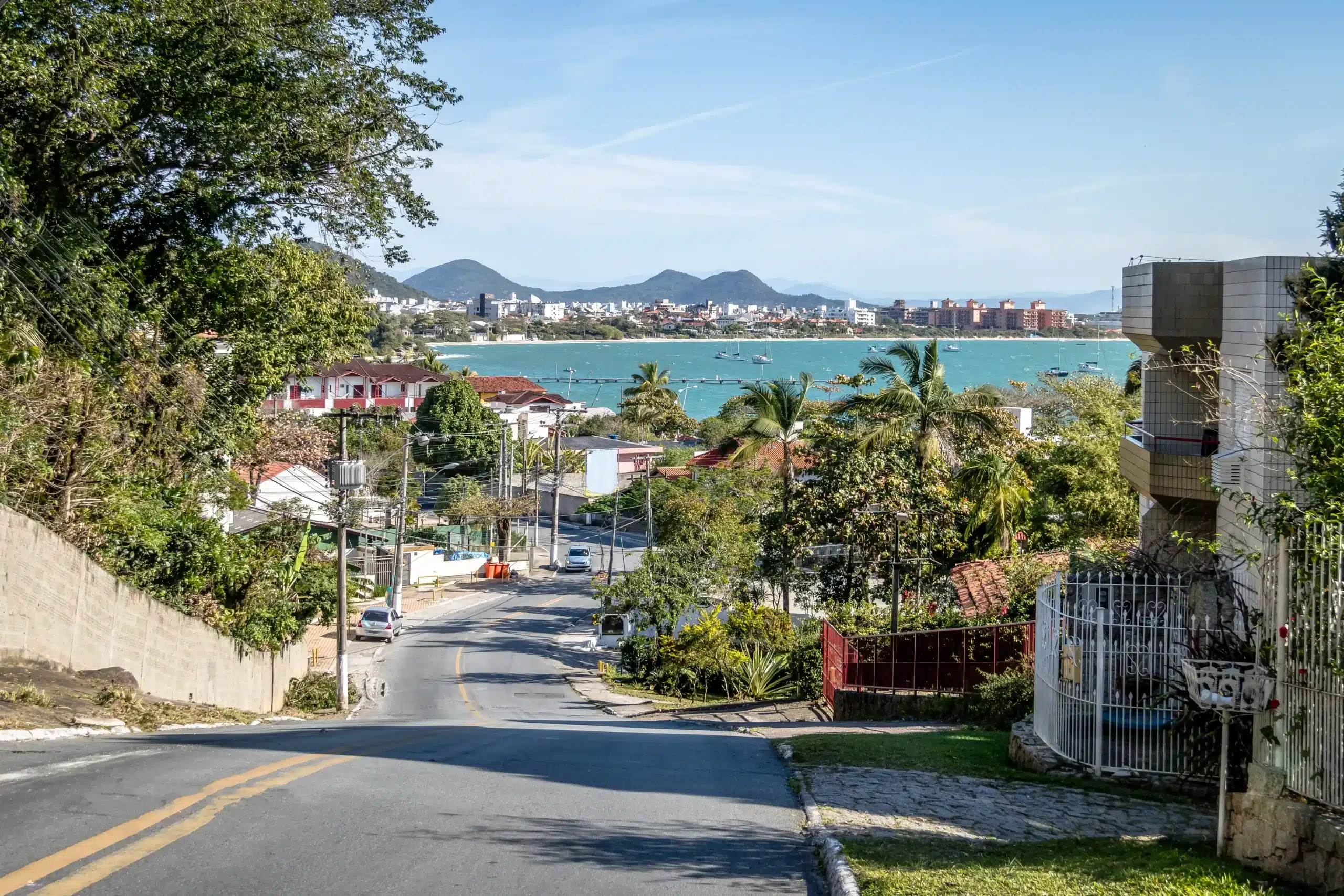 The image shows a view of Jurerê beach in Florianópolis, Santa Catarina, Brazil. It illustrates the text about Florianópolis.